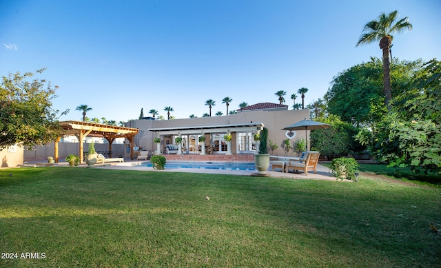 rear view of house featuring a patio, a lawn, and a pergola