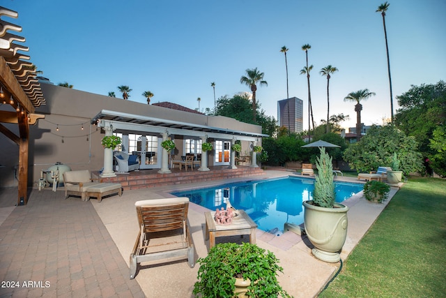 view of pool with a yard and a patio