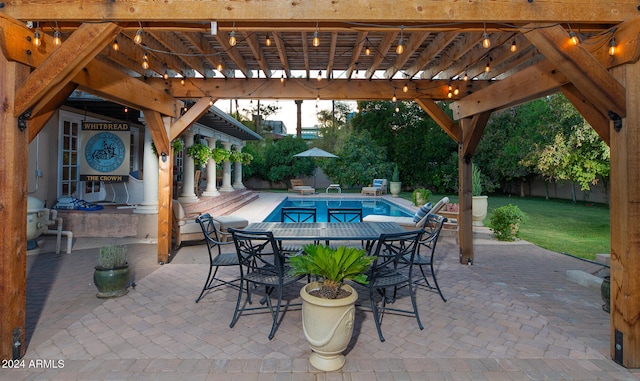 view of patio featuring a fenced in pool and a pergola