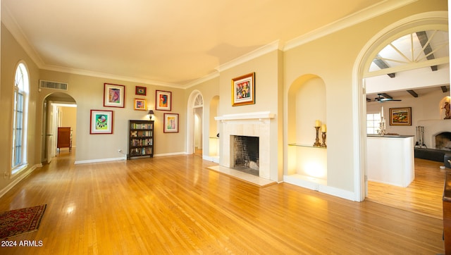 unfurnished living room with crown molding, wood-type flooring, and ceiling fan