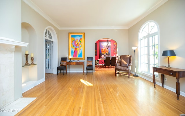 sitting room featuring ornamental molding and hardwood / wood-style flooring