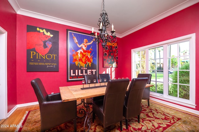 dining space featuring hardwood / wood-style floors, a chandelier, and crown molding