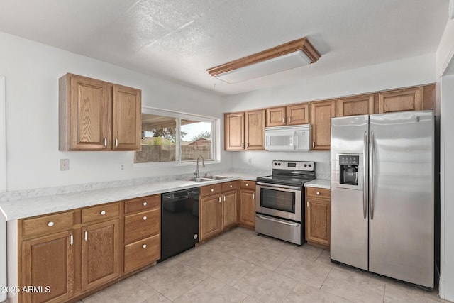 kitchen with brown cabinets, a sink, and appliances with stainless steel finishes