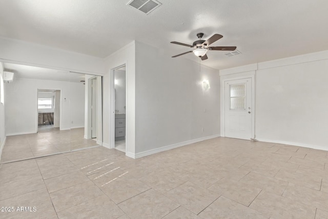 unfurnished room featuring baseboards, visible vents, light tile patterned floors, and a ceiling fan