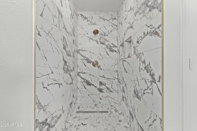 full bathroom featuring tiled shower