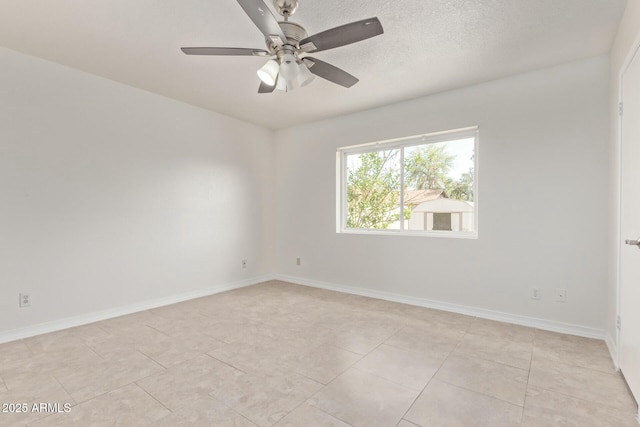 empty room featuring light tile patterned floors, ceiling fan, and baseboards