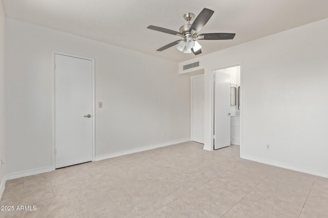 unfurnished bedroom featuring light tile patterned floors, a ceiling fan, visible vents, baseboards, and ensuite bathroom