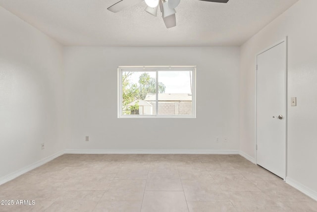 unfurnished bedroom featuring light tile patterned flooring, ceiling fan, baseboards, and a textured ceiling
