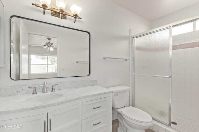 full bath with toilet, a stall shower, vanity, and plenty of natural light
