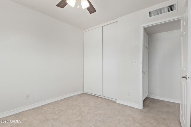 unfurnished bedroom with visible vents, ceiling fan, baseboards, and a closet