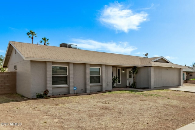 single story home featuring a garage, fence, and driveway