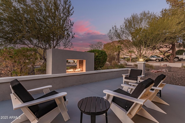 view of patio terrace at dusk