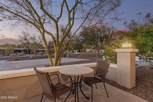 view of patio terrace at dusk