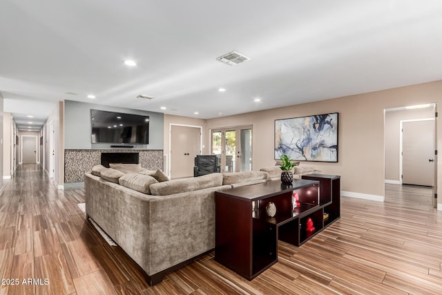 living room featuring french doors and hardwood / wood-style flooring