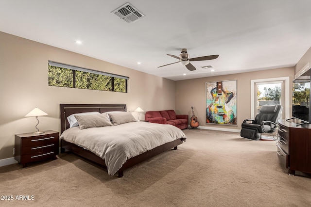 bedroom with ceiling fan, light colored carpet, and multiple windows