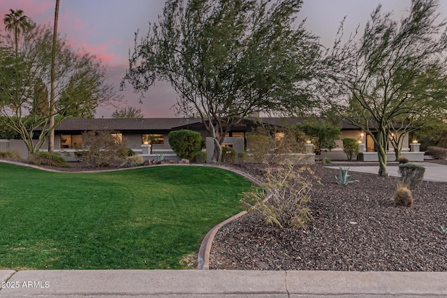 ranch-style house with a lawn