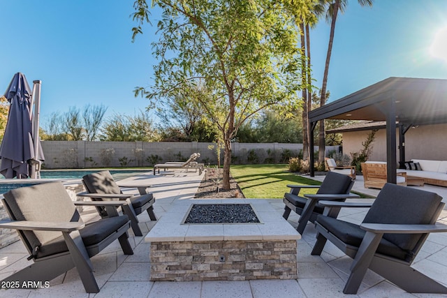 view of patio with a fenced in pool and a fire pit