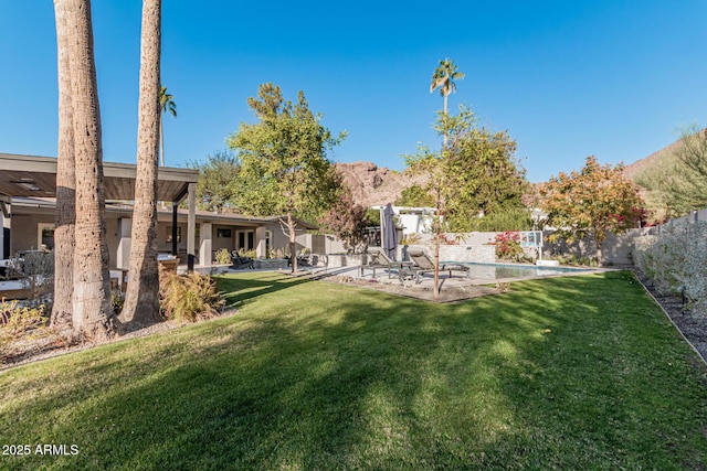 view of yard with a fenced in pool and a patio