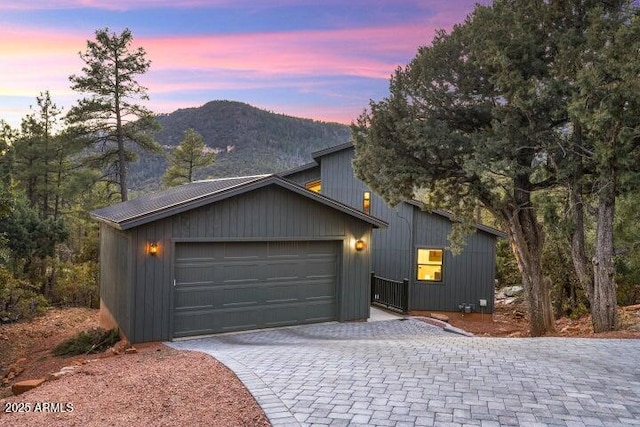 view of front of home featuring a mountain view and a garage