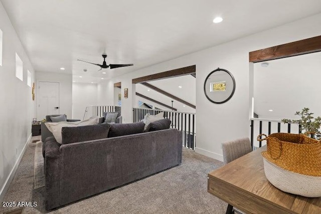 carpeted living room with ceiling fan