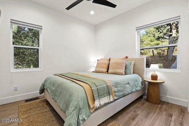 bedroom featuring hardwood / wood-style flooring and ceiling fan