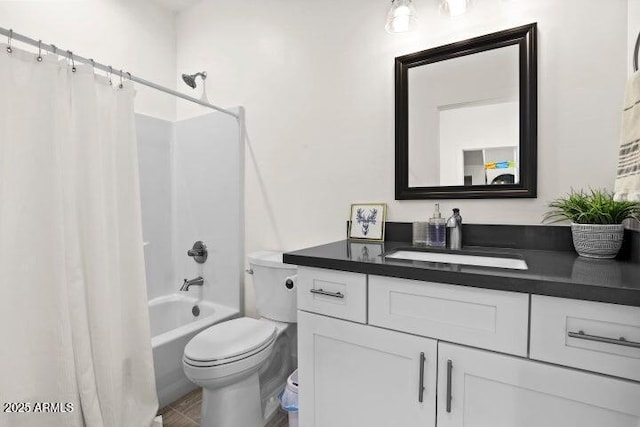 full bathroom with vanity, shower / tub combo, and toilet