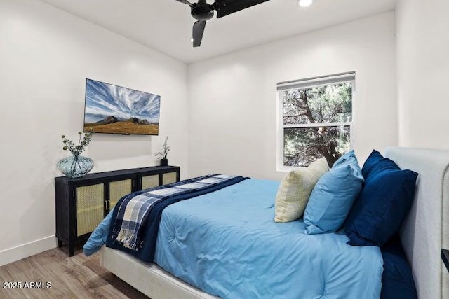 bedroom with hardwood / wood-style flooring and ceiling fan