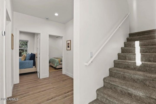 stairway featuring hardwood / wood-style flooring