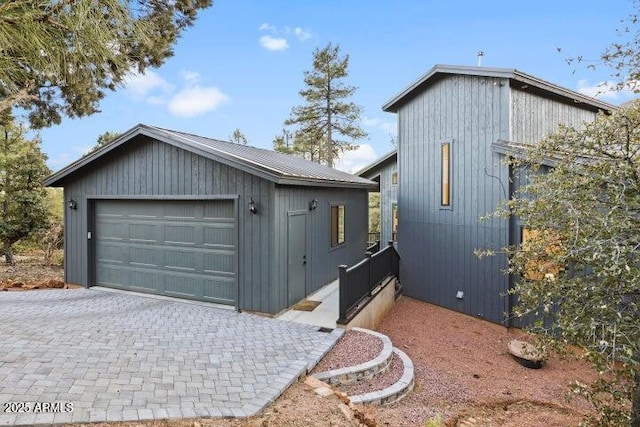 view of home's exterior with a garage and an outdoor structure