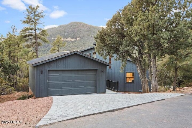 exterior space with a mountain view and a garage