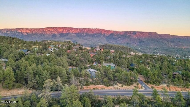 aerial view at dusk featuring a mountain view