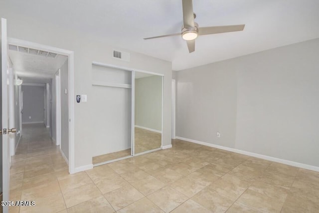 unfurnished bedroom with visible vents, ceiling fan, baseboards, light tile patterned floors, and a closet