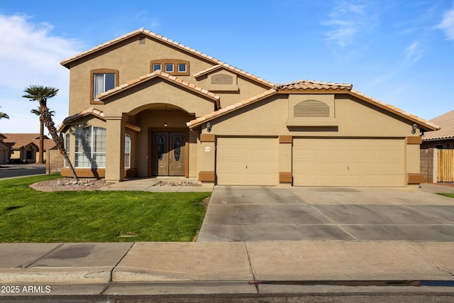 mediterranean / spanish-style house featuring a tile roof, stucco siding, concrete driveway, an attached garage, and a front lawn