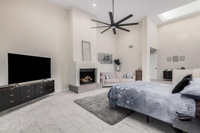 bedroom with marble finish floor, visible vents, a skylight, and a tile fireplace