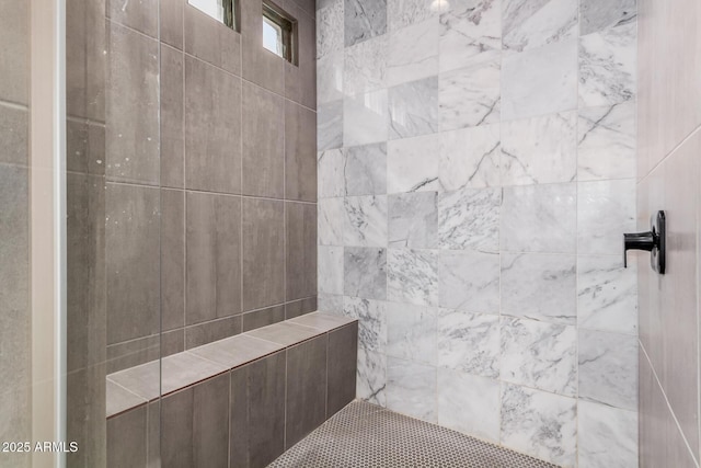 full bath featuring a tile shower