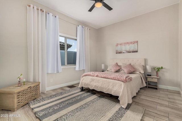 bedroom featuring wood finished floors, a ceiling fan, and baseboards