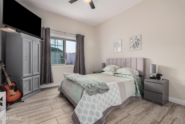 bedroom with wood tiled floor, a ceiling fan, and baseboards