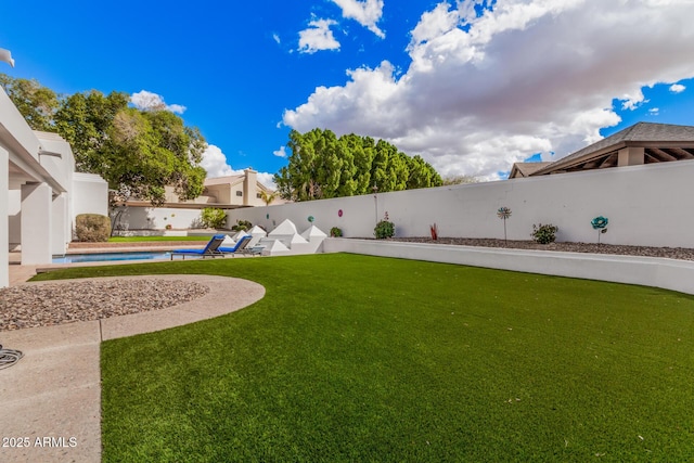 view of yard with a fenced in pool and a fenced backyard