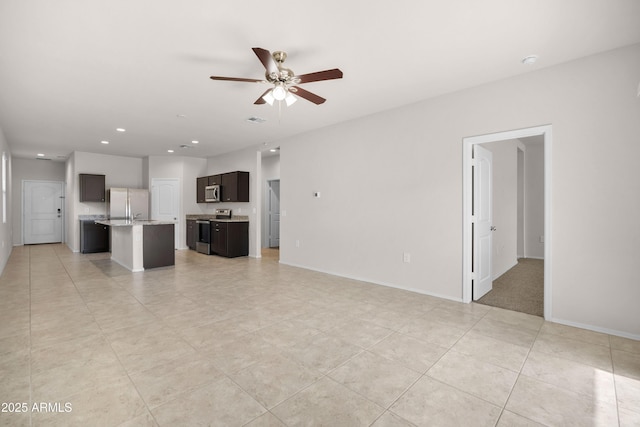 unfurnished living room with light tile patterned floors, recessed lighting, visible vents, ceiling fan, and baseboards