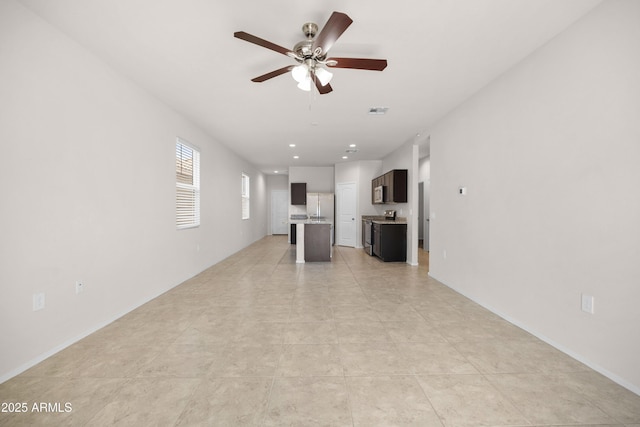 unfurnished living room featuring baseboards, visible vents, a ceiling fan, and recessed lighting