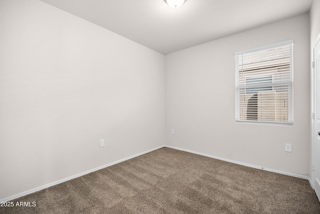 spare room with carpet flooring and baseboards