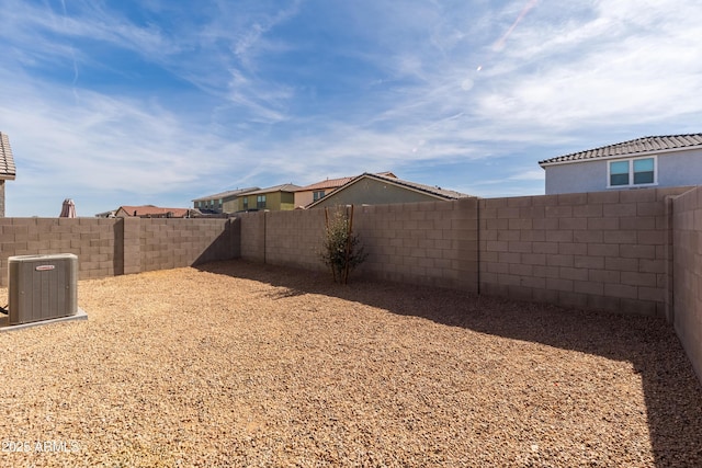 view of yard featuring a fenced backyard and central AC unit