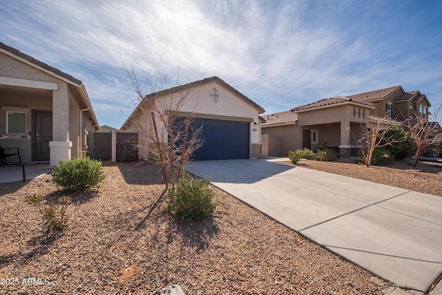 view of front of home with concrete driveway, an attached garage, and stucco siding