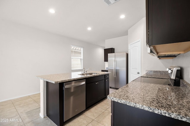 kitchen with light tile patterned floors, visible vents, a kitchen island with sink, stainless steel appliances, and a sink