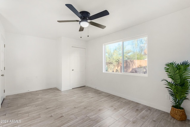 empty room featuring ceiling fan and light hardwood / wood-style floors