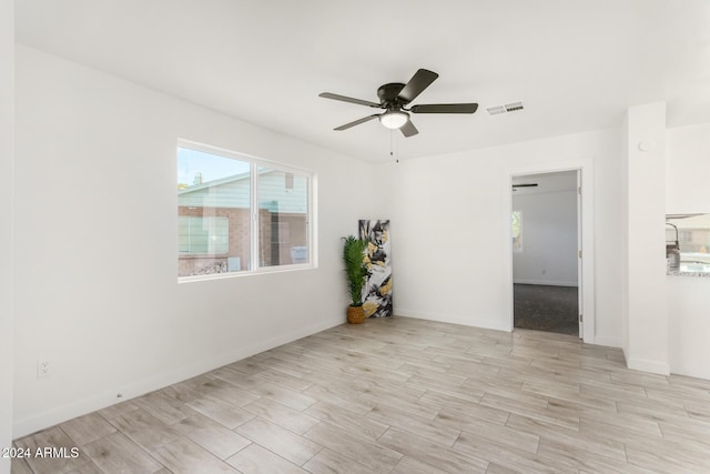 unfurnished room featuring ceiling fan and light wood-type flooring