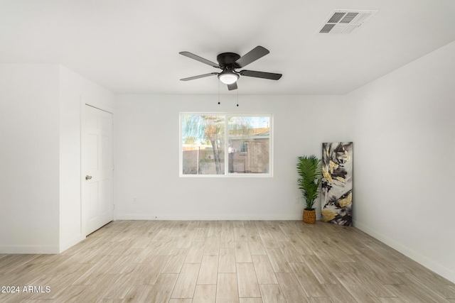 empty room with light wood-type flooring and ceiling fan