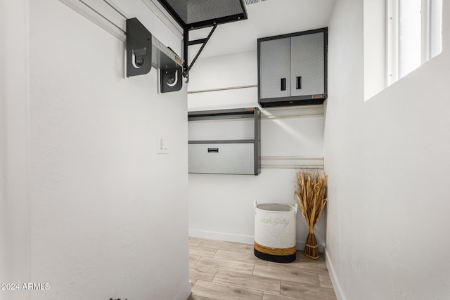 walk in closet featuring light hardwood / wood-style floors