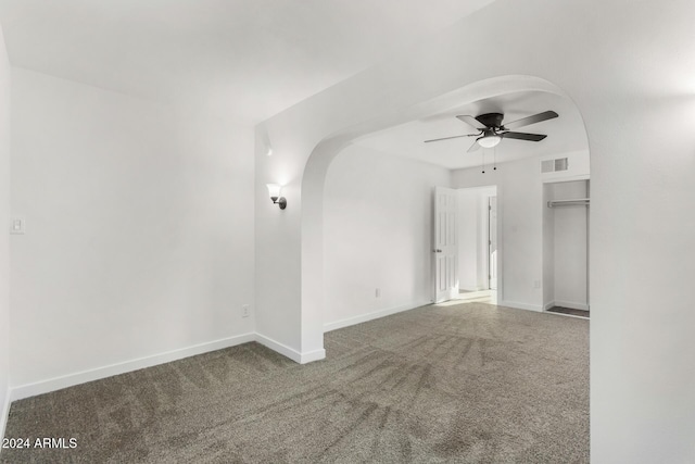 carpeted spare room featuring ceiling fan