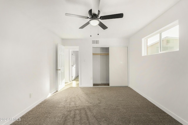 unfurnished bedroom featuring carpet flooring, ceiling fan, and a closet